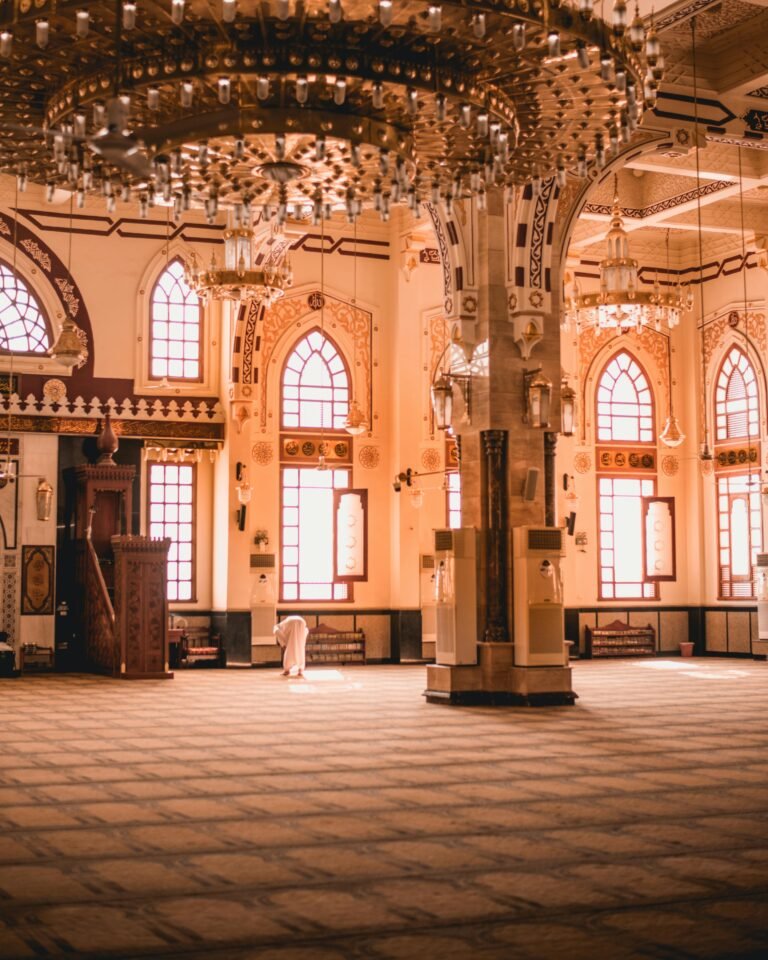 Beautiful mosque interior showcasing intricate ceilings and chandeliers, highlighting Islamic architecture and design.